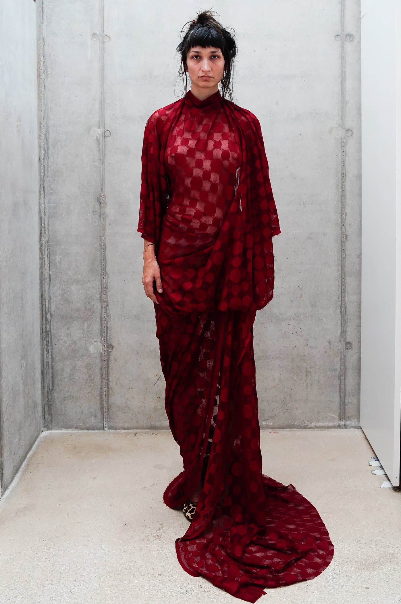 Red sheer check gown, draped at the hip with a pooled train