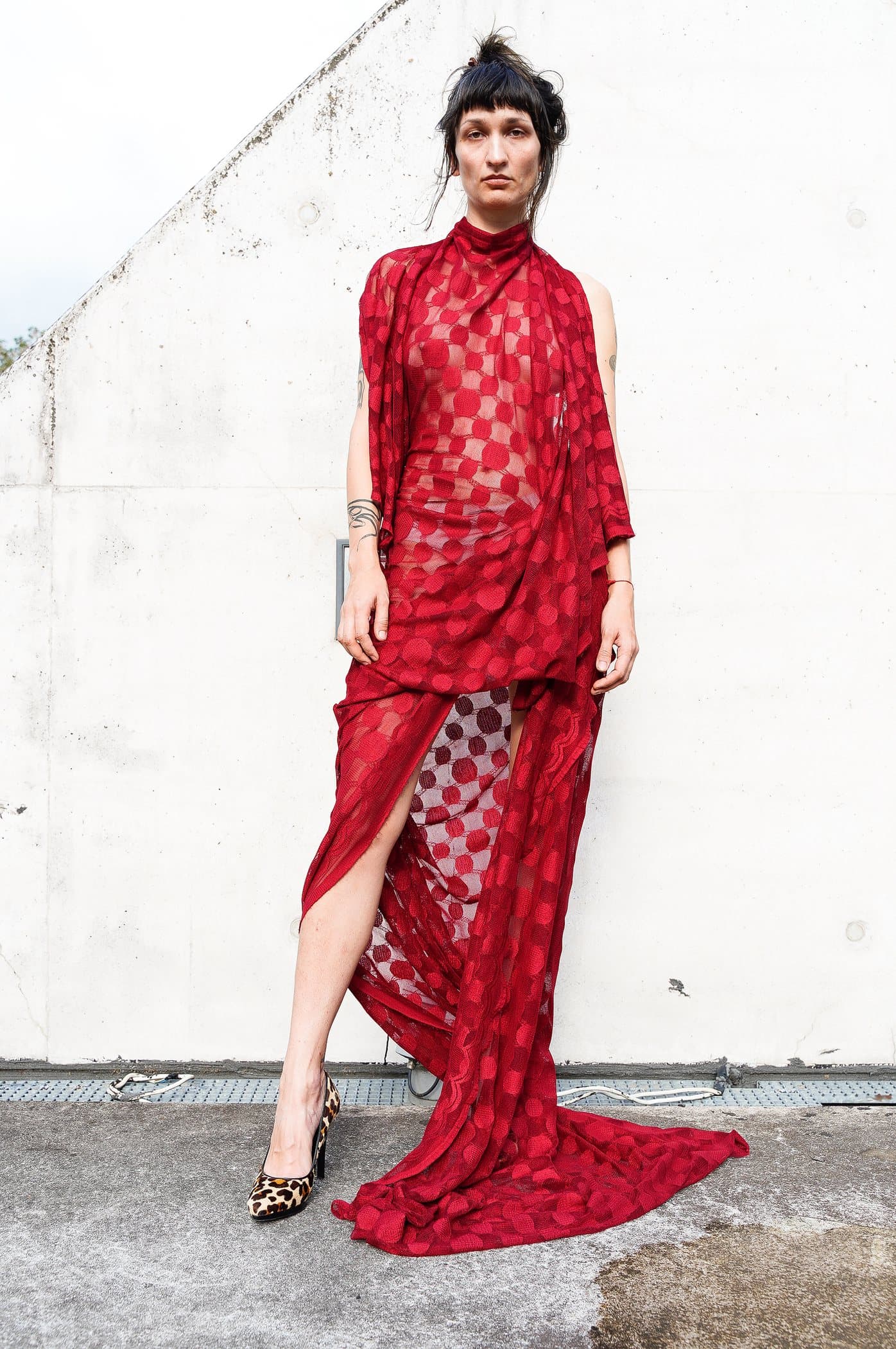 Red sheer check gown, draped at the hip with a pooled train