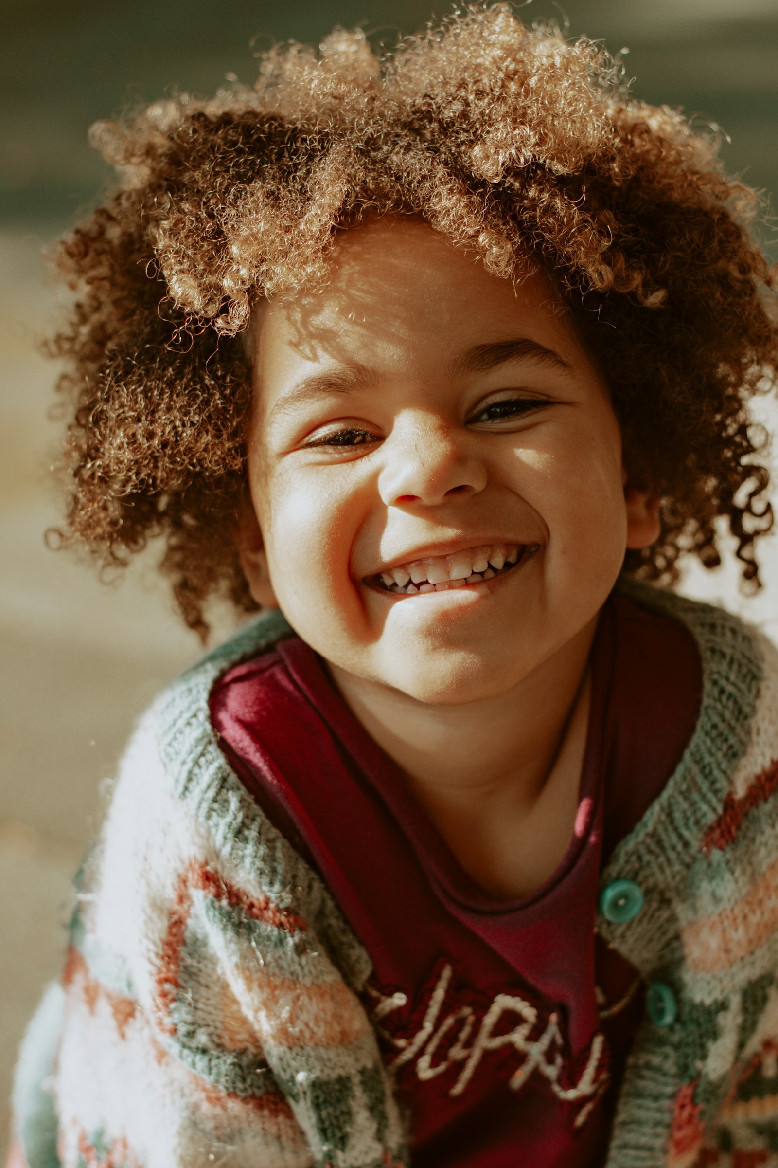 Girl in red and white knit sweater smiling